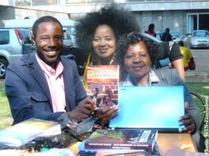 farayi-mungoshi-left-poses-with-officials-from-library-of-congress-during-the-2016-zibf